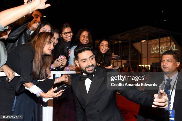 Abhishek Bachchan takes selfies with fans at the "Husband Material" premiere during 2018 Toronto International Film Festival at Roy Thomson Hall on...
