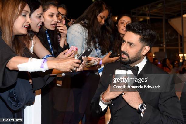 Abhishek Bachchan takes selfies with fans at the "Husband Material" premiere during 2018 Toronto International Film Festival at Roy Thomson Hall on...