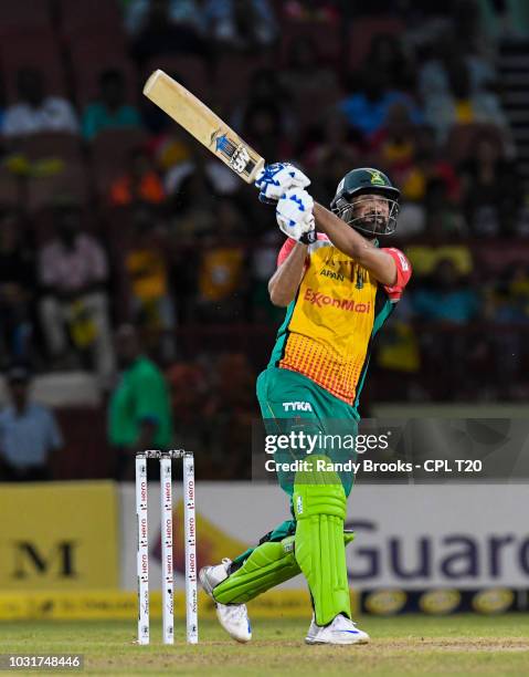 In this handout image provided by CPL T20, Sohail Tanvir of Guyana Amazon Warriors hits 6 to win the Hero Caribbean Premier League Play-Off match 31...