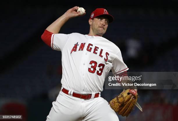 Pitcher Jim Johnson of the Los Angeles Angels of Anaheim pitches during the first inning of the MLB game against the Texas Rangers at Angel Stadium...