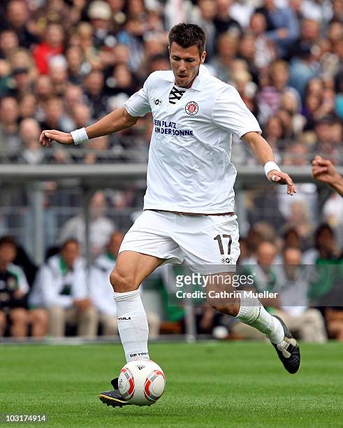 Fabian Boll of FC St. Pauli runs with the ball during the pre-season friendly match against Racing Santander at Millerntor Stadium on July 30, 2010...