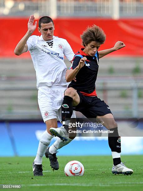 Ralph Gunesch of FC St. Pauli battles for the ball with Luque of Racing Santander during the pre-season friendly match at Millerntor Stadium on July...