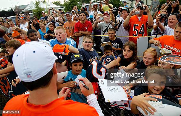 Fans clamor for an autograph from Jay Cutler of the Chicago Bears after a summer training camp practice at Olivet Nazarene University on July 30,...