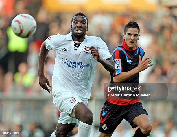 Richard Sukuta-Pasu of FC St. Pauli battles for the ball with Jose Antonio Picon of Santander during the pre-season friendly match at Millerntor...