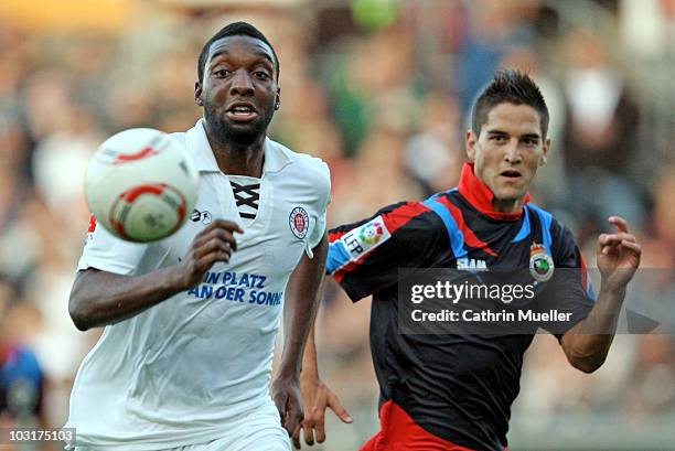 Richard Sukuta-Pasu of FC St. Pauli battles for the ball with Jose Antonio Picon of Santander during the pre-season friendly match at Millerntor...