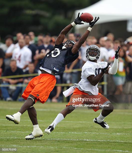 Zack Bowman of the Chicago Bears intercepts a pass intended for Earl Bennett during a summer training camp practice at Olivet Nazarene University on...