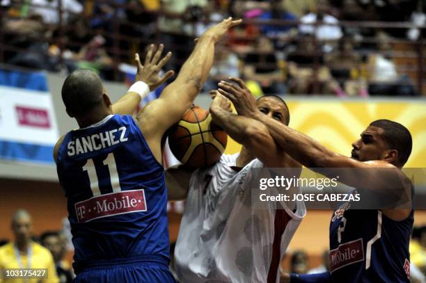 Ricardo Sanchez and Angel Vasallo of Puerto Rico vie for the ball with Noe Alonzo of Mexico during the XXI Central American & Caribbean Games...