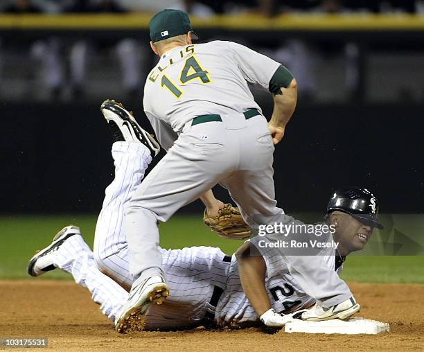 Dayan Viciedo of the Chicago White Sox slides back safely into second base under the tag of Mark Ellis of the Oakland Athletics on July 30, 2010 at...