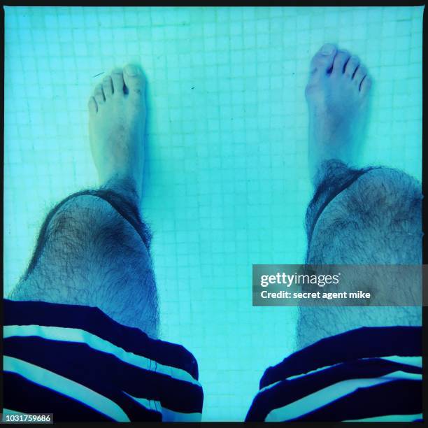 man legs in pool - cannonball diving stock-fotos und bilder