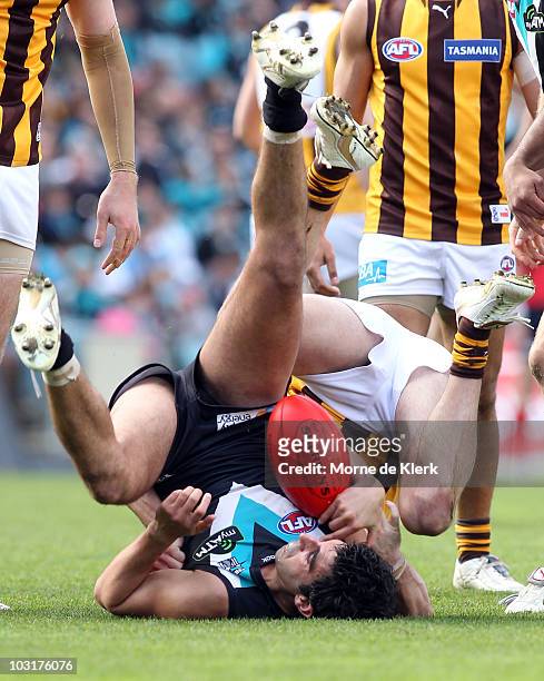 Domenic Cassisi of the Power is tackled during the round 18 AFL match between Port Power and the Hawthorn Hawks at AAMI Stadium on July 31, 2010 in...