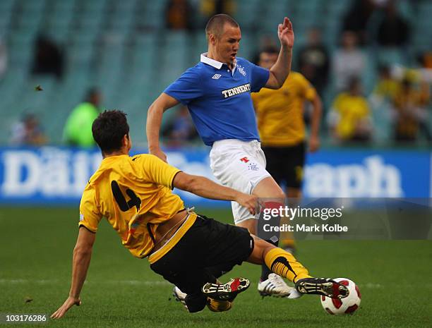 Kenny Miller of Rangers is tackled by Kostas Manolas of Athens during the pre-season friendly match between AEK Athens FC and Glasgow Rangers at the...