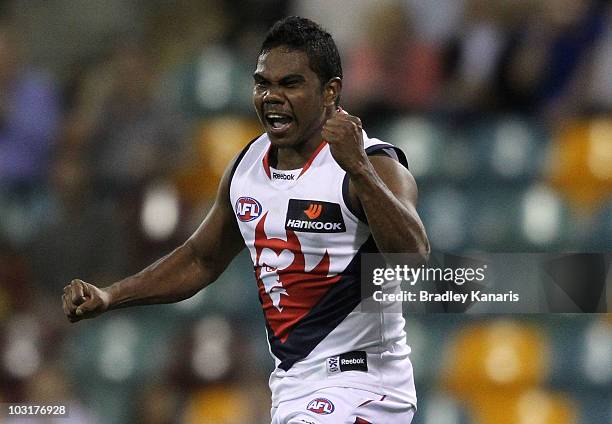 Austin Wonaeamirri of the Demons celebrates after scoring a goal during the round 18 AFL match between the Brisbane Lions and the Melbourne Demons at...