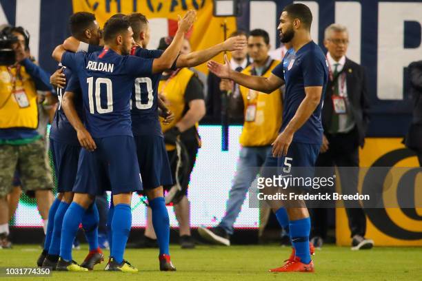 Cristian Roldan and Cameron Carter-Vickers of the USA celebrate a 1-0 victory over of Mexico at Nissan Stadium on September 11, 2018 in Nashville,...