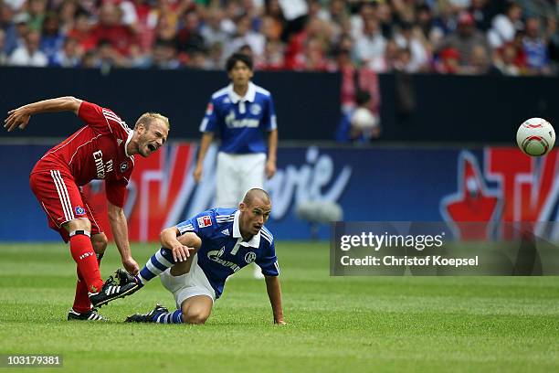 Peer Kluge of Schalke tackles David Jarolim of Hamburg during the LIGA total! Cup 2010 match between FC Schalke 04 and Hamburger SV at the Veltins...