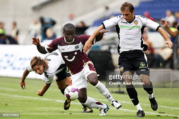 Didier Ya Konan of Hannover is challenged by Alexis Ruano Delgado and Joaquin Sanchez Rodriguez of Valencia during the pre-season friendly match...
