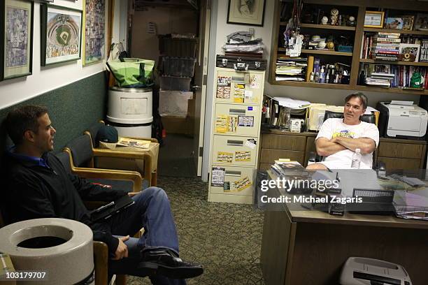 Boston Red Sox General Manager Theo Epstein sitting in Oakland Athletics General Managers Billy Beane office prior to the game against the Oakland...