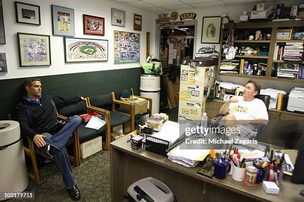 Boston Red Sox General Manager Theo Epstein sitting in Oakland Athletics General Managers Billy Beane office prior to the game against the Oakland...