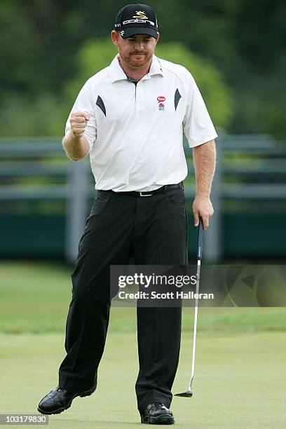 Holmes celebrates as he holes a putt for birdie on the 18th green to finish with a ten-under par 60 during the third round of the Greenbrier Classic...