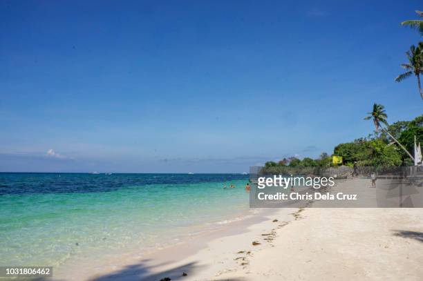 sunny day at alona beach in bohol, philippines - bohol philippines stock pictures, royalty-free photos & images