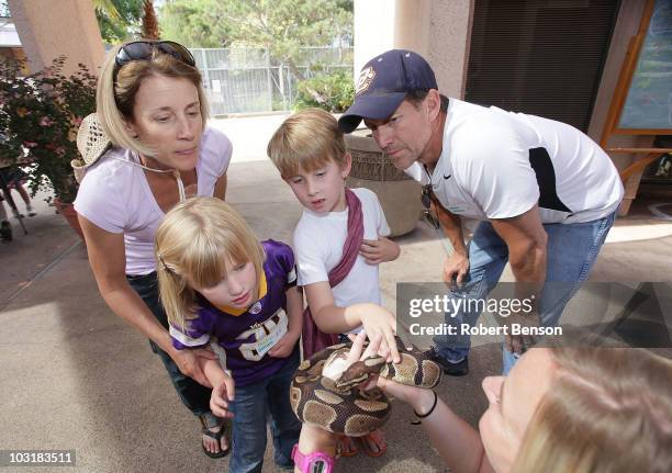 James Denton , his daughter Malin , son Sheppard and wife Erin watch as a zoo worker displays a python snake at the San Diego Zoo on July 31, 2010 in...