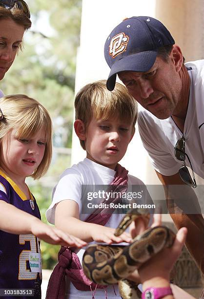 James Denton , his daughter Malin , son Sheppard and wife Erin watch as a zoo worker displays a python snake at the San Diego Zoo on July 31, 2010 in...