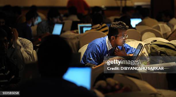 Indian Information Technology professionals work on their laptops during an 'Open Hack Day' programme organised by the global search engine Yahoo! in...