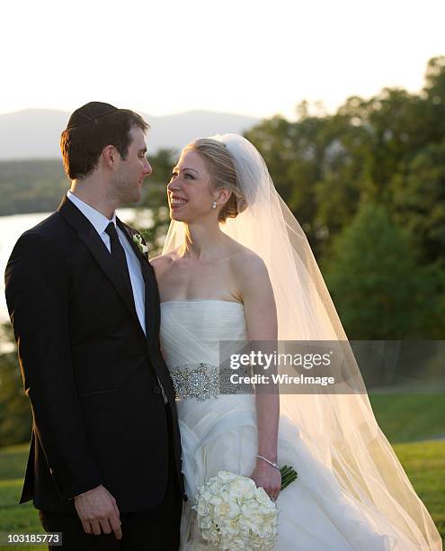 In this handout image provided by Barbara Kinney, Marc Mezvinsky and Chelsea Clinton pose during their wedding at the Astor Courts Estate on July 31,...