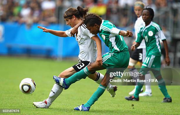 Sylvia Arnold of Germany and Esther Sunday of Nigeria compete for the ball during the 2010 FIFA Women's World Cup Final match between Germany and...