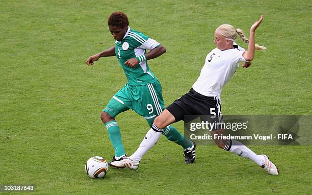 Kristina Gessat of Germany and Desire Oparanozie of Nigeria battle for the ball during the FIFA U20 Women's World Cup Final match between Germany and...