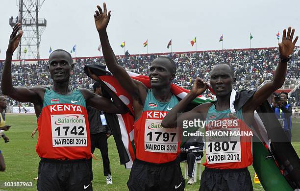Kenyans Kiptoo Mark, Soy Edwin and Yator Vincent celebrate after their finish in the first, second and third position in the 5000M men final on...