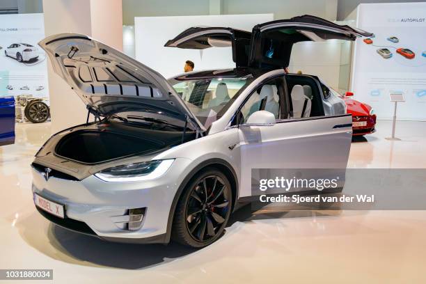 Tesla Model X P90D full electric luxury crossover SUV car front view. The rear Falcon Wing doors are open. The Model X P90D is the highest...