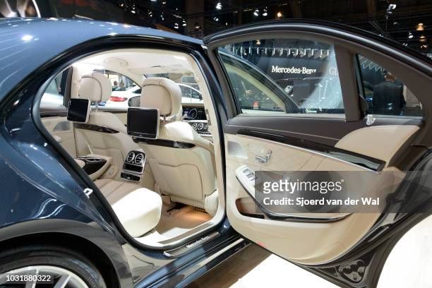 Interior on a Mercedes-Benz S500e Plug-in Hybrid luxury limousine sedan. The vehicle is fitted with light leather seats, wood trim and a large...