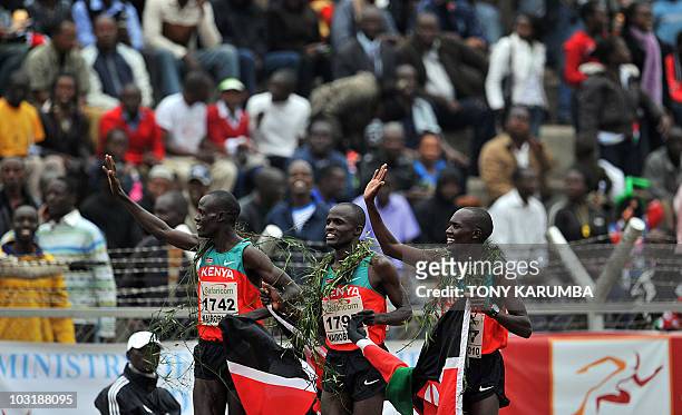 Kenya's winning trio Vincent Yator , Edwin Soy and Mark Kiptoo celebrate after the finish of the Men's 5000 metres final event August 1, 2010 during...