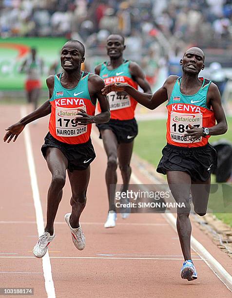 Kenyas Soy Edwin crosses the finishing line past teammate Yator Vincent in the 5000M men final on August 1, 2010 on the fifth day the17th CAA African...