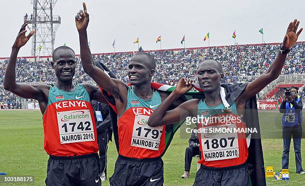 Kenyans Kiptoo Mark, Soy Edwin and Yator Vincent celebrate after their finish in the first, second and third position in the 5000M men final on...