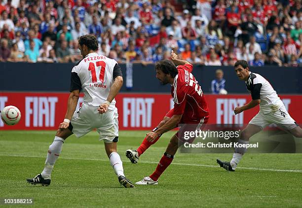 Ruud van Nistelrooy of Hamburg scores the first goal against Kevin Pezzoni of Koeln and Mato Jajala of Koeln during the LIGA total! Cup 2010 third...