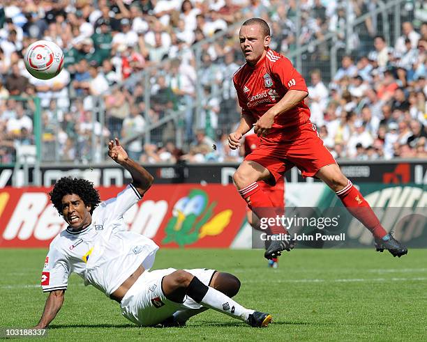 Liverpools Jay Spearing gets to the ball in front of Dante during the pre-season friendly match between Borussia M'Gladbach and Liverpool at the...