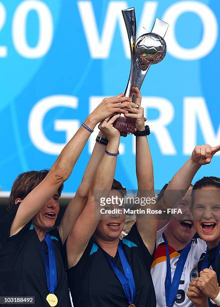 Bettina Wiegmann , assistant coach and Maren Meinert , head coach of Germany lift the trophy after winning the 2010 FIFA Women's World Cup Final...