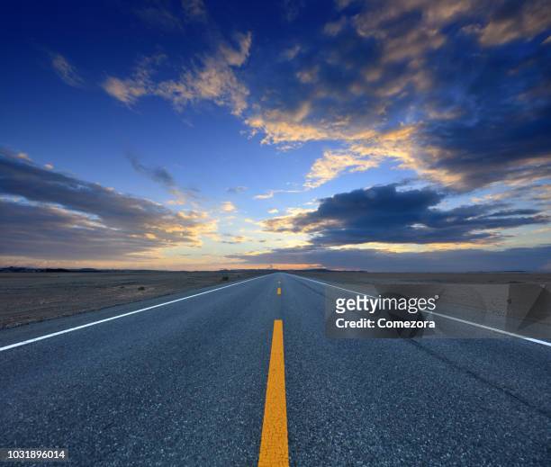 highway at sunrise day - dramatic sky perspective stock pictures, royalty-free photos & images
