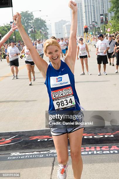 Andrea Powell crosses the finish line at the Rock 'n' Roll Chicago Half Marathon on August 1, 2010 in Chicago, Illinois.