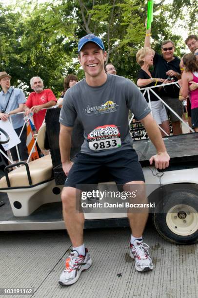 Jake Pavelka rests after crossing the finish line at the Rock 'n' Roll Chicago Half Marathon on August 1, 2010 in Chicago, Illinois.