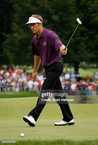 Stuart Appleby of Australia reacts as his birdie putt falls on the 18th green to finish with an 11-under par 59 during the final round of the...