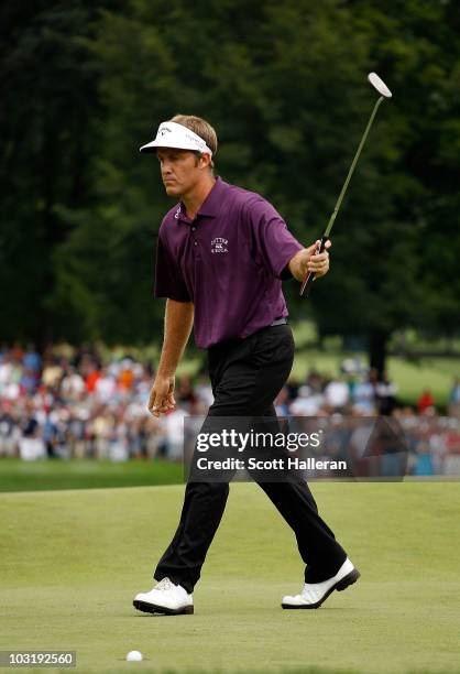 Stuart Appleby of Australia reacts as his birdie putt falls on the 18th green to finish with an 11-under par 59 during the final round of the...