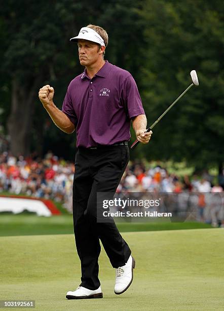 Stuart Appleby of Australia reacts after his birdie putt on the 18th green to finish with an 11-under par 59 during the final round of the Greenbrier...