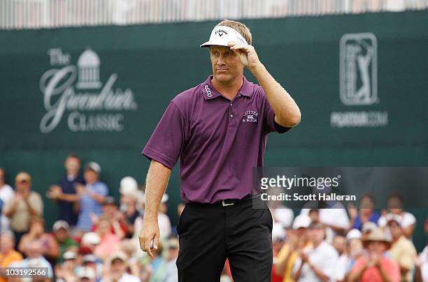 Stuart Appleby of Australia waves to the gallery after his birdie putt on the 18th green to finish with an 11-under par 59 during the final round of...