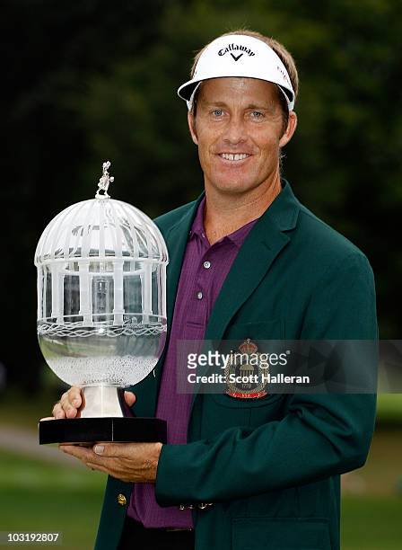 Stuart Appleby of Australia poses with the winner's trophy after his victory at the Greenbrier Classic on The Old White Course at the Greenbrier...