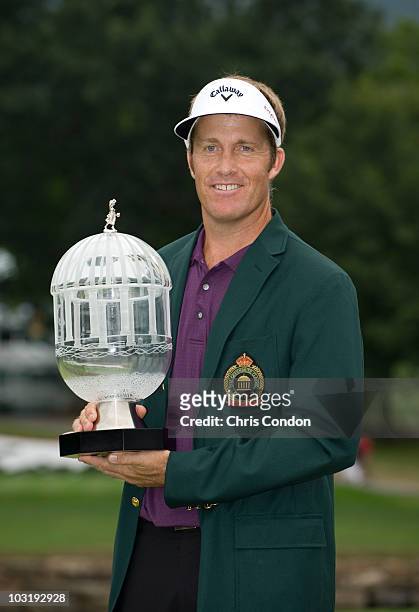 Stuart Appleby of Australia poses with the tournament tropy after scoring a 59 and winning The Greenbrier Classic at The Greenbrier Resort on August...