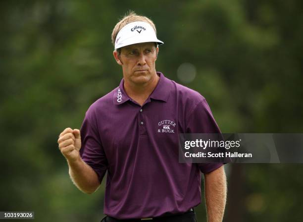 Stuart Appleby of Australia celebrates a birdie putt on the 17th hole during the final round of the Greenbrier Classic on The Old White Course at the...