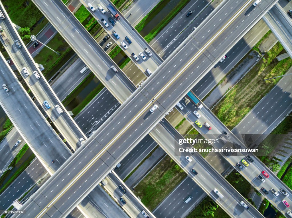 Aerial top view city traffic road on 4-way street intersection circle roundabout in bangkok, thailand.