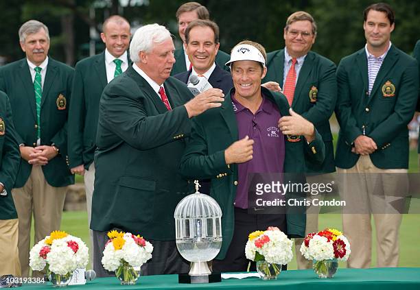 Stuart Appleby of Australia receives the winner's jacket from tournament host Jim Justice and the trophy after scoring a 59 and winning The...